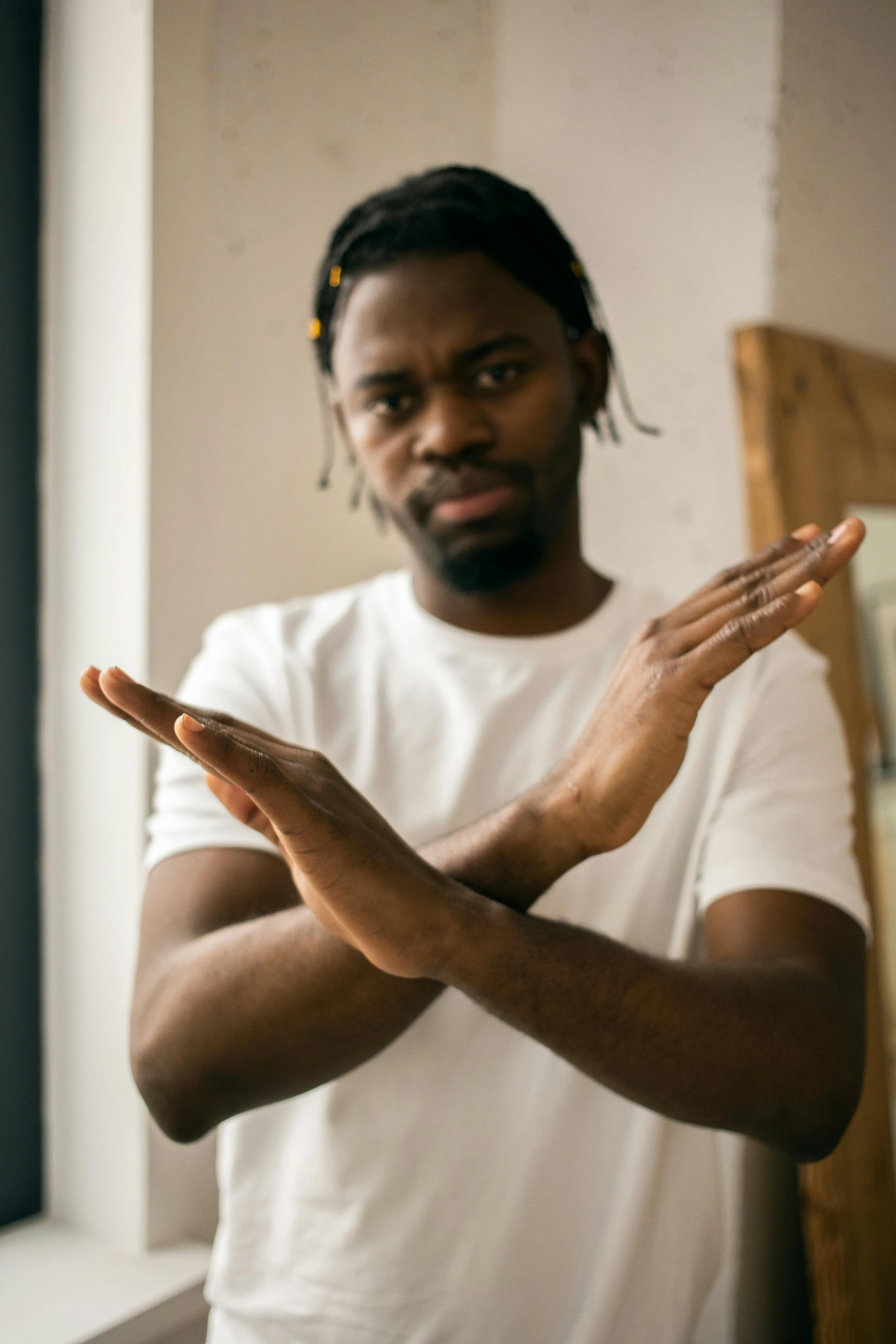 A man crosses his arms, signalling he does not want to be touched